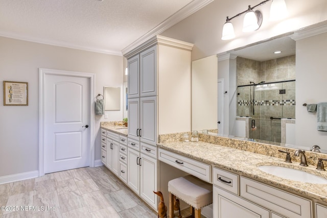 bathroom with crown molding, vanity, an enclosed shower, and a textured ceiling