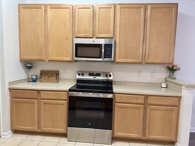 kitchen featuring appliances with stainless steel finishes and light brown cabinets