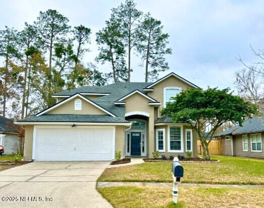 view of front of property with a garage and a front yard