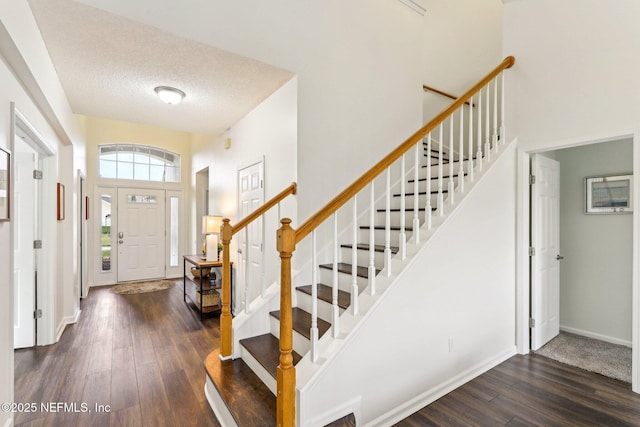 entryway featuring a textured ceiling and dark hardwood / wood-style flooring