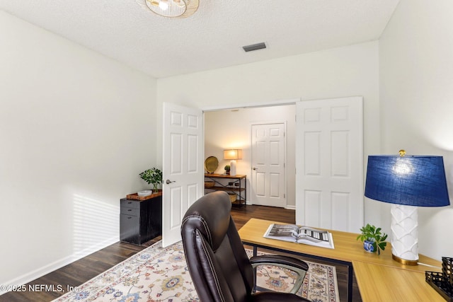 office area featuring dark hardwood / wood-style flooring and a textured ceiling