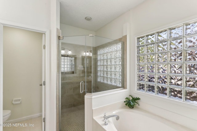 bathroom featuring lofted ceiling, plus walk in shower, a textured ceiling, tile patterned floors, and toilet