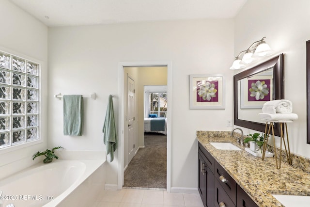 bathroom with vanity, tile patterned floors, and a tub to relax in