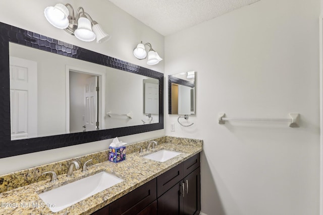 bathroom with vanity and a textured ceiling