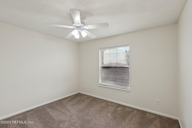 carpeted empty room featuring ceiling fan and a textured ceiling