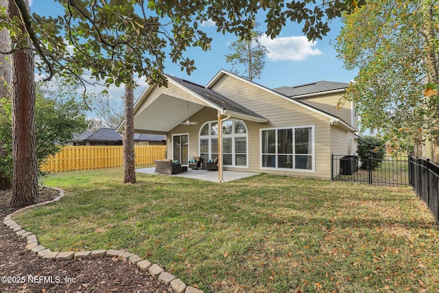 back of house with an outdoor living space, a yard, and a patio