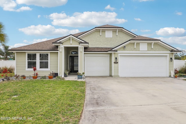 view of front of house with a garage, a front yard, driveway, and a shingled roof