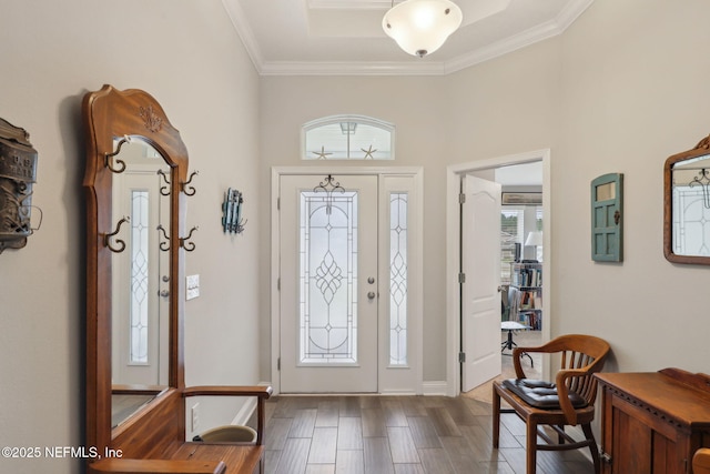 foyer entrance with wood finished floors and crown molding