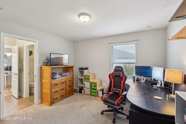 office space featuring visible vents and a textured ceiling