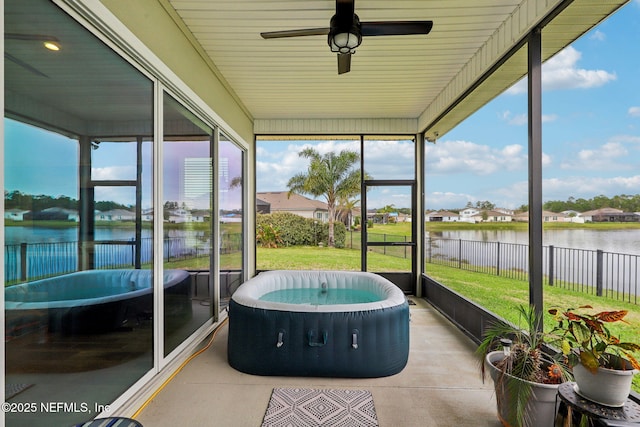 sunroom / solarium with a water view