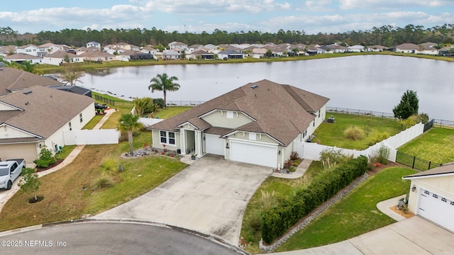 birds eye view of property featuring a residential view and a water view