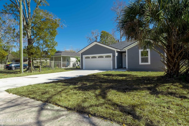 view of front of home featuring a garage and a front lawn