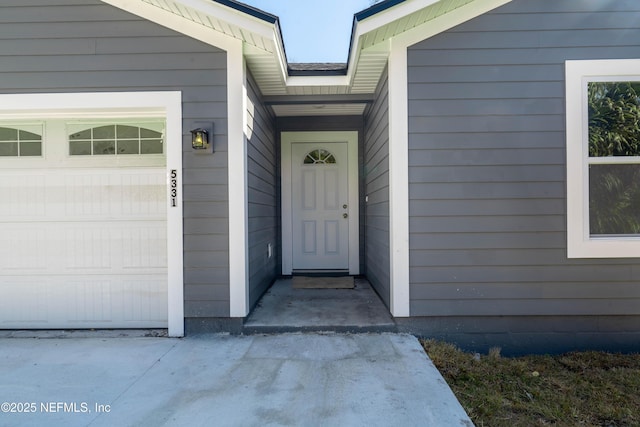 doorway to property featuring a garage