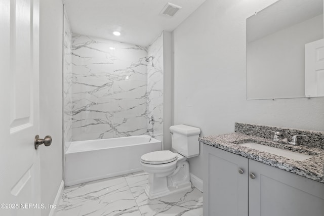 full bathroom featuring tiled shower / bath, vanity, and toilet