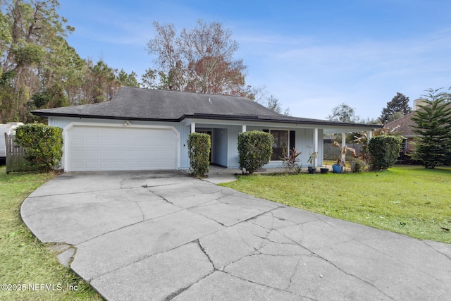 ranch-style house featuring a garage, a front yard, and a porch