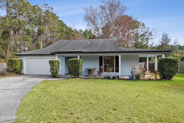 view of front of house featuring a garage and a front lawn