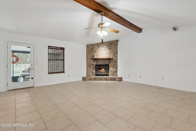 unfurnished living room featuring vaulted ceiling with beams, a stone fireplace, a textured ceiling, and ceiling fan