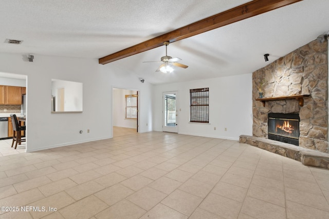 unfurnished living room featuring light tile patterned flooring, a stone fireplace, lofted ceiling with beams, a textured ceiling, and ceiling fan