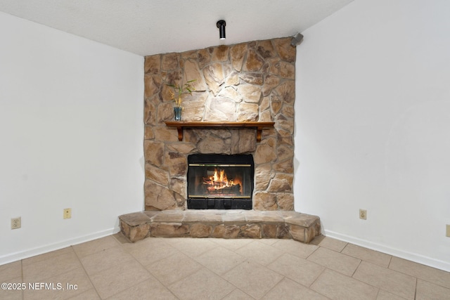 room details with a stone fireplace and a textured ceiling