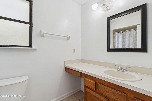 bathroom with vanity, tile patterned floors, and toilet