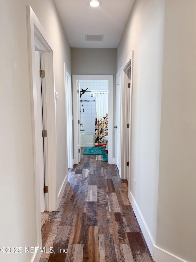 hallway with dark hardwood / wood-style flooring