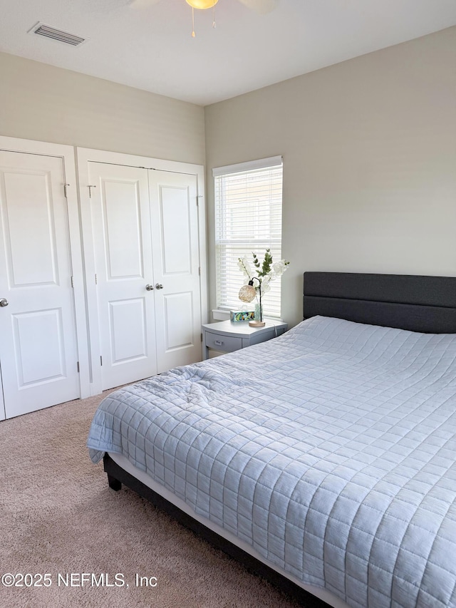 bedroom featuring ceiling fan, carpet floors, and a closet