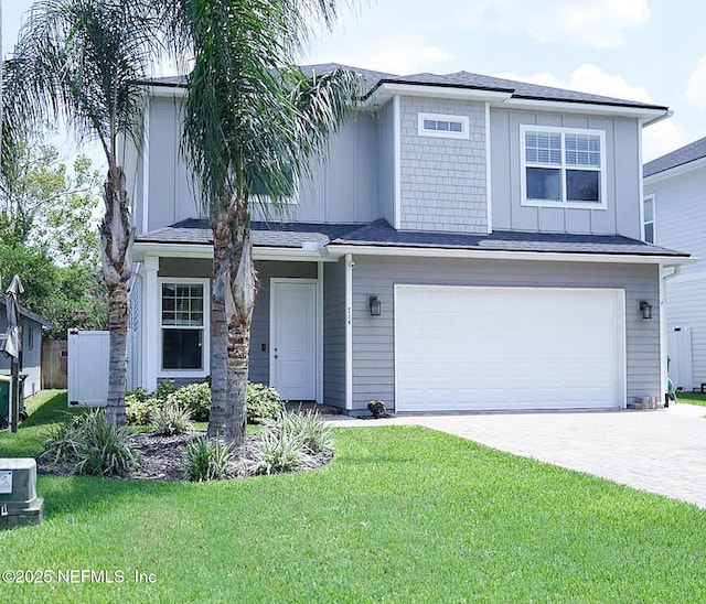 view of front of home featuring a garage and a front yard