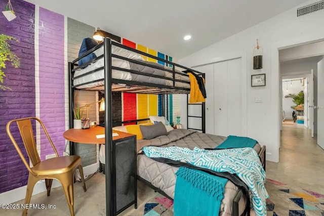 bedroom with brick wall and a closet