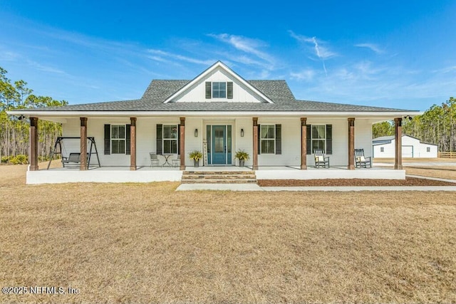 country-style home with a porch and a front lawn