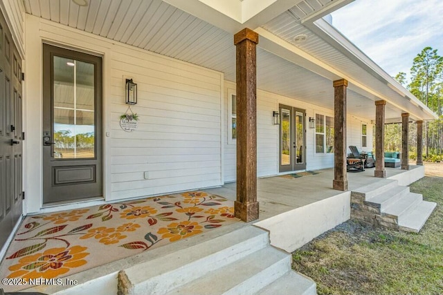 view of exterior entry featuring a porch