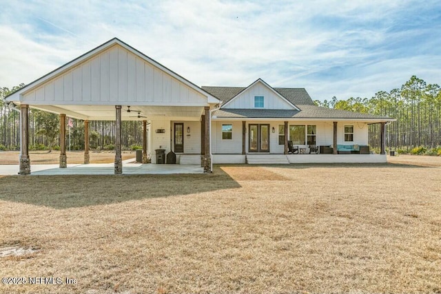 back of house featuring a porch and a yard