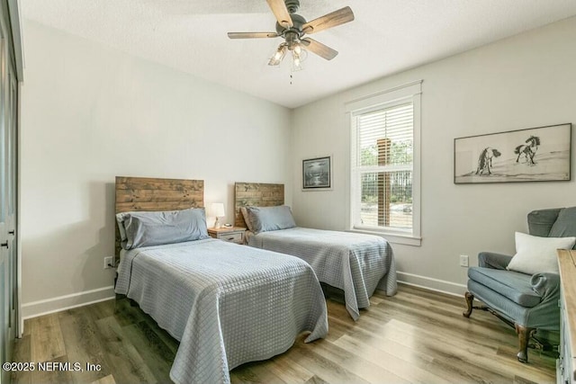 bedroom featuring hardwood / wood-style flooring and ceiling fan