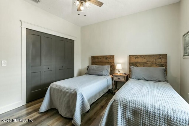 bedroom with ceiling fan, dark hardwood / wood-style flooring, and a closet