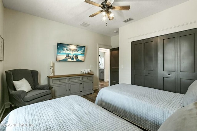 bedroom with ceiling fan, wood-type flooring, and a closet