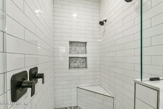 bathroom with tiled shower