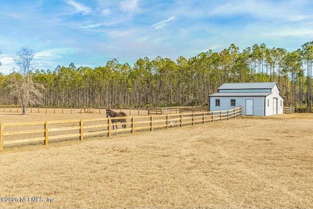 view of yard featuring an outdoor structure and a rural view