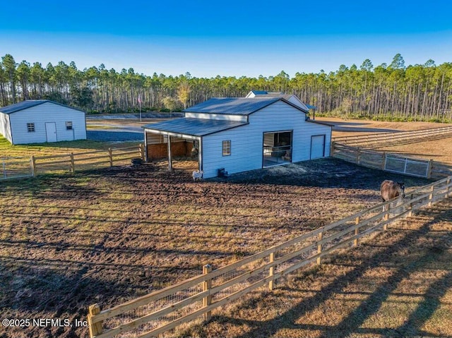 view of horse barn with a rural view