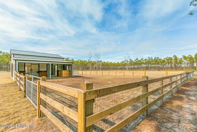 view of stable featuring a rural view