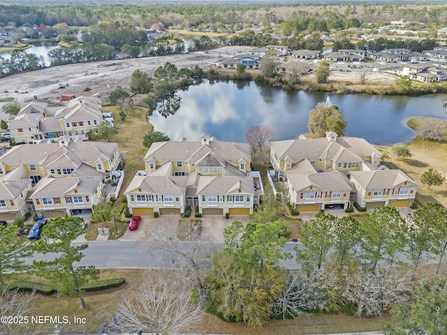 drone / aerial view with a residential view and a water view