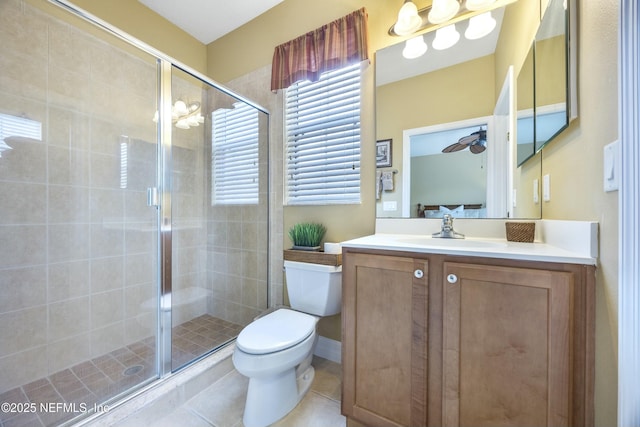 full bathroom featuring vanity, tile patterned floors, toilet, and a stall shower