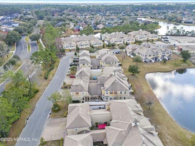 drone / aerial view featuring a residential view and a water view