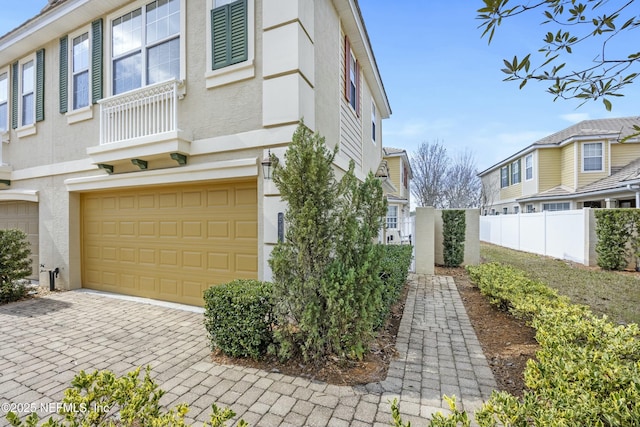 view of property exterior with fence, a residential view, and stucco siding