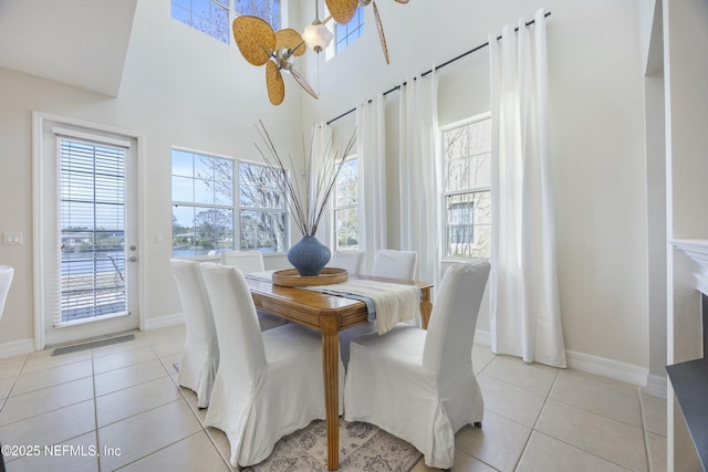 dining room with light tile patterned floors, baseboards, and a healthy amount of sunlight