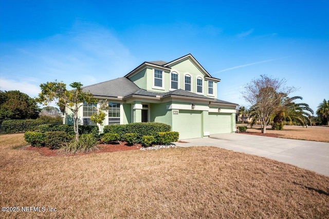 view of front property with a garage and a front lawn