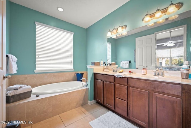 bathroom featuring a relaxing tiled tub, ceiling fan, tile patterned floors, and vanity