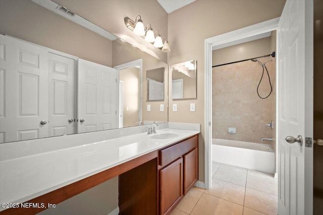 bathroom with vanity, tiled shower / bath combo, and tile patterned flooring