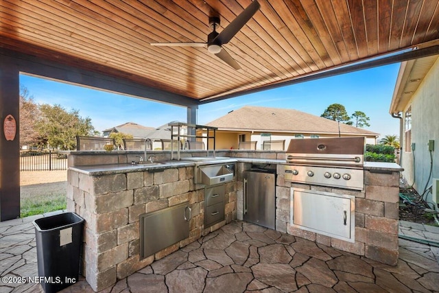 view of patio with grilling area, an outdoor kitchen, sink, and ceiling fan