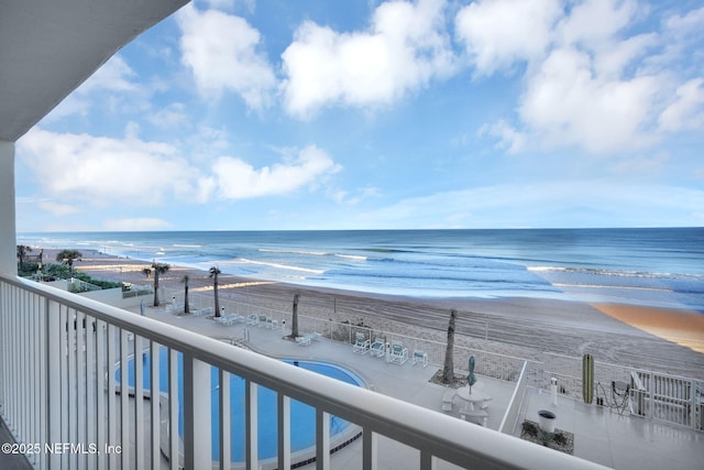 exterior space with a water view and a view of the beach