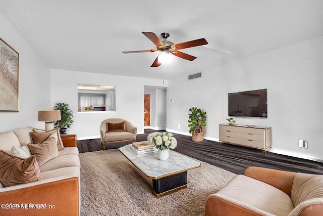 living room with dark wood-type flooring and ceiling fan