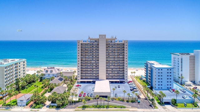 bird's eye view featuring a view of the beach and a water view